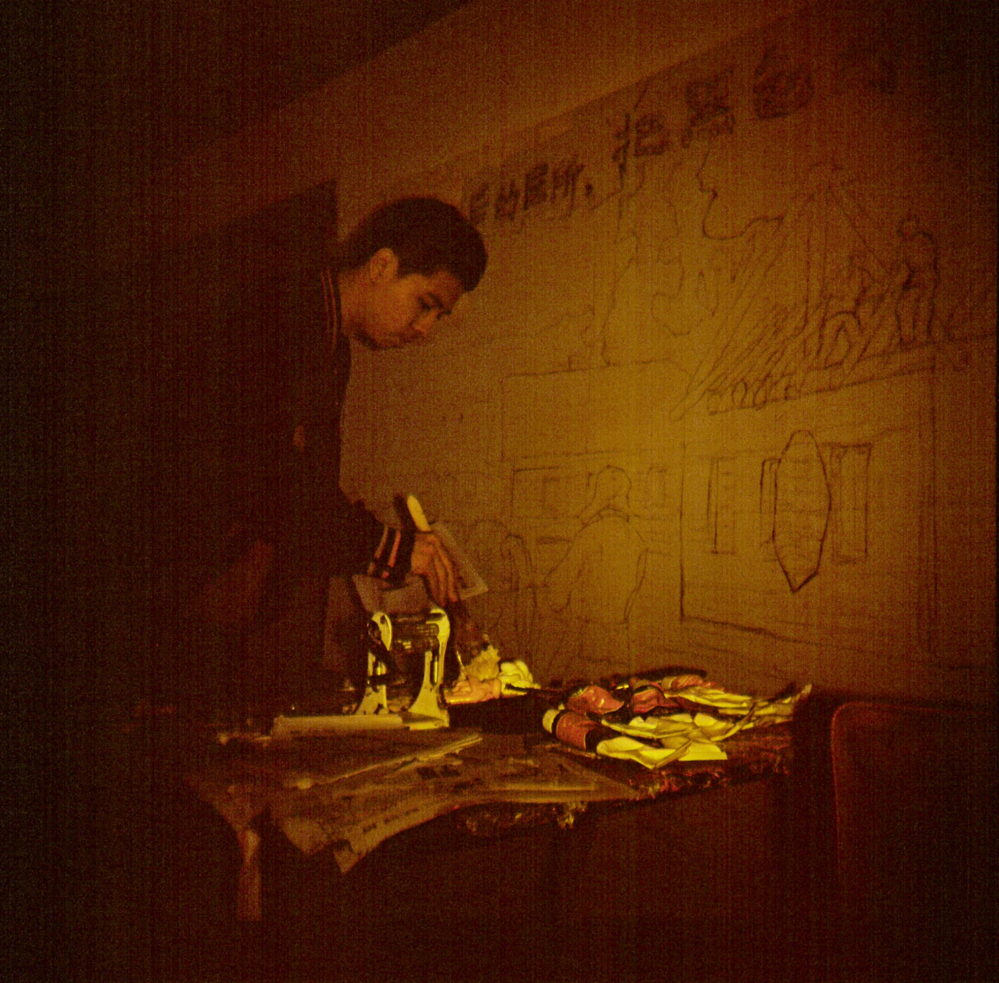 Artist working in a dimly lit studio